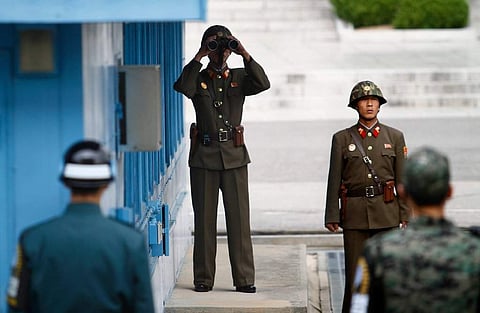 Soldiers from North Korea, center, and South Korea at Panmunjom, a border village. (Photo | Associated Press)