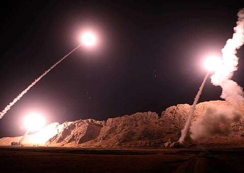 In this photo released on Monday, Oct. 1, 2018, by the Iranian Revolutionary Guard, missiles are fired from city of Kermanshah in western Iran targeting the Islamic State group in Syria. Iran's paramilitary Revolutionary Guard said Monday it launched ball