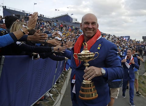 Europe team captain Thomas Bjorn holds the trophy as he is greeted by spectators after Europe won the Ryder Cup on the final day of the 42nd Ryder Cup in Saint-Quentin-en-YvelinesFrance, Sept. 30, 2018. (Photo | AP)