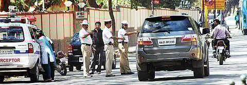 File image of traffic policemen checking driver details