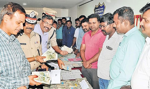 City Police Commissioner T Suneel Kumar inspects the properties seized by CCB Police displayed at Police Commissioner Office in Bengaluru on Wednesday. (Photo | EPS)