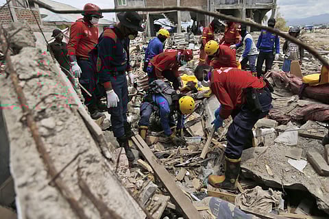 Firemen dig through the rubble in search for tsunami victims in Palu, Central Sulawesi, Indonesia. ( Photo | AP)