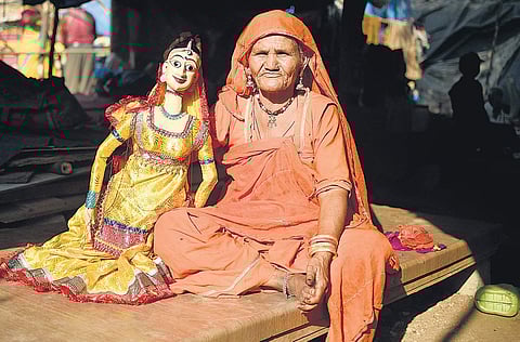 One of the Rajasthani artisans exhibits a puppet. (Photo | Vinay Madapu/EPS)