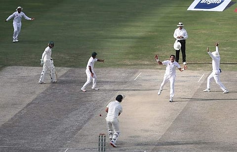 Pakistani cricketer Muhammad Abbas (2R) celebrates after taking the wicket of Australian batsman Mitch Marsh during the fourth day of play of the first Test cricket match in the series between Australia and Pakistan at the Dubai International Stadium in D