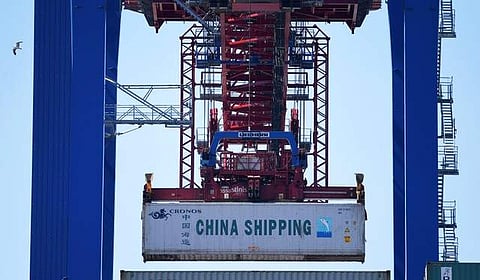 A container of China Shipping is loaded at a loading terminal in the port of Hamburg Germany July 27, 2018. (Photo | Reuters)