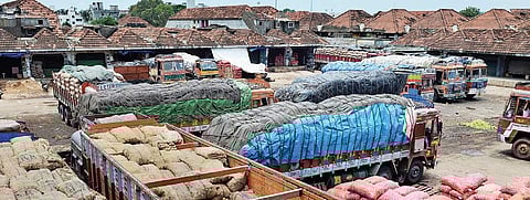 Trucks unloading goods inside Koyambedu market | P Jawahar