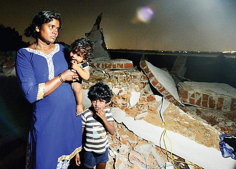 Hemavathi, with her two children, near her demolished house | shiba prasad sahu