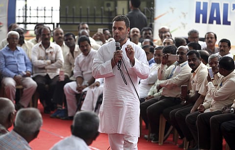 India's opposition Congress party President Rahul Gandhi, center, speaks to working and retired employees of the state-run aerospace and defense company Hindustan Aeronautics Ltd (HAL) outside company's corporate headquarters in Bangalore, India, Saturday