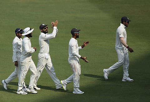 Indian cricket captain Virat Kohli and teammates leave ground on tea break during the third day of the second cricket test match between India and West Indies in Hyderabad | AP
