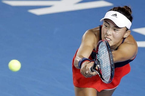 Wang Qiang of China hits a return during her women's singles semi-final match against Garbine Muguruza of Spain at the Hong Kong Open tennis tournament on October 13, 2018. | AFP