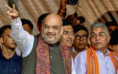 BJP National President Amit Shah flashes the victory sign as West Bengal BJP President Dilip Ghosh R looks on during a public rally in Kolkata on Saturday August 11 2018. (Photo | PTI)