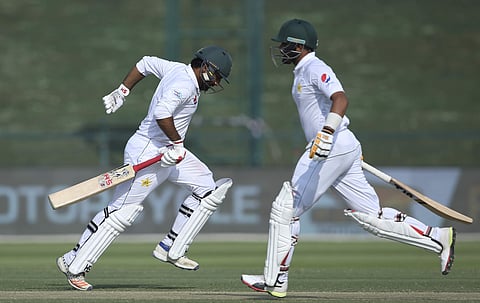 Pakistan's Sarfaraz Ahmed, left, and Babar Azam, run between the wickets against Australia during their test match in Abu Dhabi. (Photo | AP)