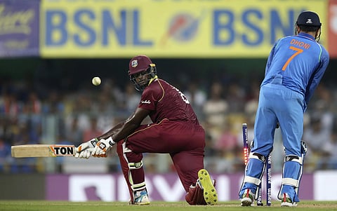 West Indies' batsman Jason Holder, left, looks back as he is bowled out by India's Yuzvendra Chahal during the first one-day international cricket match between India and West Indies in Gauhati, India, Sunday, Oct. 21, 2018. | AP