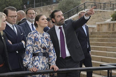 A handout picture provided by the Lebanese photo agency Dalati and Nohra on October 18, 2018, shows Lebanese Prime Minister Saad Hariri (C) escorting Crown Princess Victoria of Sweden (C-L) and Prince Daniel of Sweden (L) during a tour of downtown Beirut.