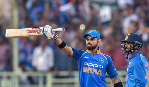 Virat Kohli raises his bat to celebrate a milestone. (Photo | PTI)