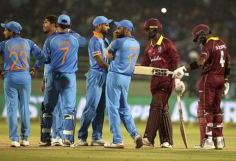 West Indies' batsmen Shai Hope (R) and Kemar Roach (SR) react as they stand next to Indian players after the second ODI | AP