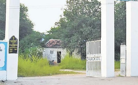 The church authorities clean up the dense bushes in the Mission Compound, wherein three boys immolated themselves, in Jagtial on Thursday | Express