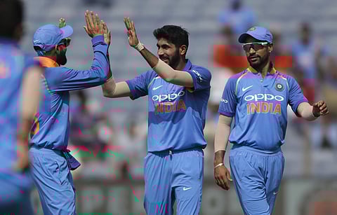India's Jasprit Bumrah, center, celebrates with teammates the dismissal of West Indies' batsman Kieran Powell during the third one-day international cricket match between India and West Indies in Pune. (Photo | AP)