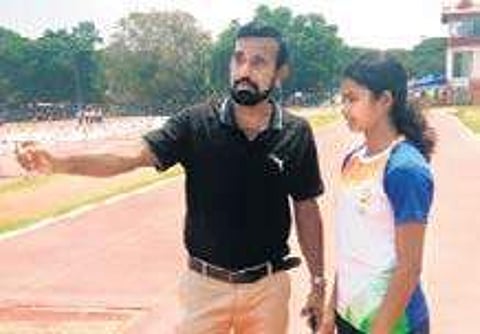 Vishnupriya Jayaprakashan and her coach C Haridas | Express