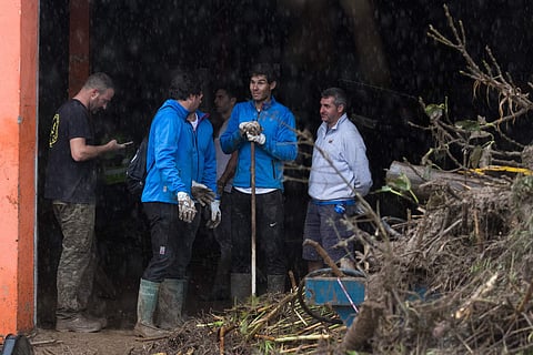 Spanish tennis player Rafael Nadal works with residents to clear the mud from their houses after flooding in Sant Llorenc, 60 kilometers (40 miles) east of Mallorca's capital (File | AP)