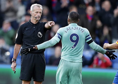 Referee Martin Atkinson gestures towards Alexandre Lacazette during the English Premier League soccer match between Crystal Palace and Arsenal | AP