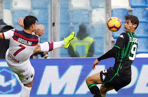Ouch: Sassuolo's Filip Djuricic, right, is hit with the ball kicked by Bologna's Riccardo Orsolini | AP