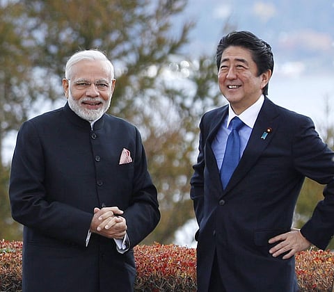 PM Narendra Modi, left, and Japan's Prime Minister Shinzo Abe, right, pose for a photo at a hotel garden in Yamanakako village, Yamanashi prefecture. (Photo | AP)