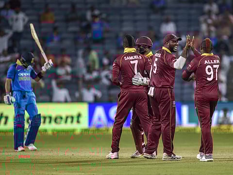 West Indies team players celebrate the dismissal of Indian captain Virat Kohli during the 3rd ODI cricket match in Pune Saturday Oct 27 2018. (Photo | PTI)