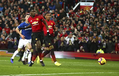 Manchester United's Paul Pogba scores the opening goal during the English Premier League soccer match between Manchester United and Everton FC at Old Trafford in Manchester, England, Sunday Oct. 28, 2018. | AP
