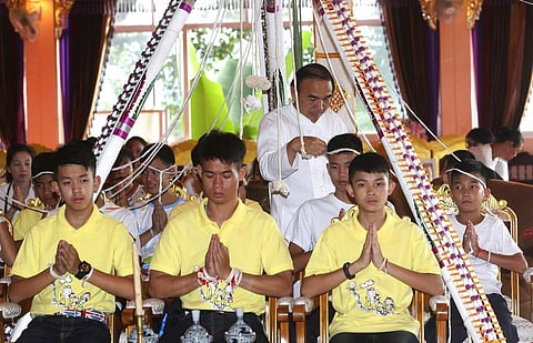 Soccer coach Ekkapol Janthawong, second from left, and members of the rescued soccer team attend a Buddhist ceremony. (Photo | AP)