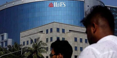 People walk past a building of IL&FS (Infrastructure Leasing and Financial Services Ltd.) outside its headquarters in Mumbai, September 25, 2018. | Reuters