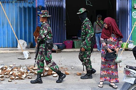 Indonesian soldiers patrol the area to stop looters at a market in Palu. ( Photo | AFP)