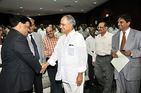 EPS file image of Gitam University president MVVS Murthy greeting varsity alumnus.