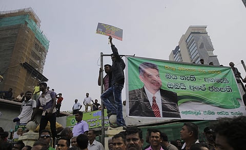 Supporters of Sri Lanka's sacked prime minister Ranil Wickremesinghe shout slogans denouncing president Maithripala Sirisena during a protest rally out side the prime ministers official residence in Colombo | AP