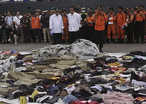 Indonesian President Joko Widodo, center, Transportation Minister Budi Karya Sumadi, left, and Chief of National Search and Rescue Agency Muhammad Syaugi, right, inspect debris retrieved from the waters where Lion Air flight JT 610 is believed to have cra