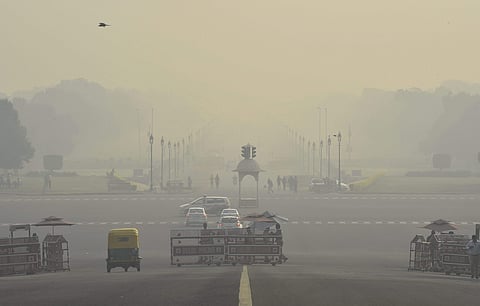 Vehicles ply at Rajpath as thick haze engulfs Vijay Chowk in New Delhi Monday October 29 2018. | PTI
