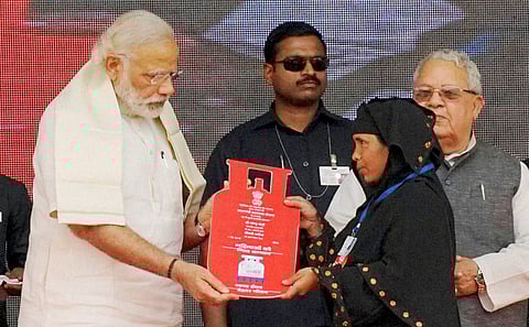 Prime Minister Narendra Modi presents cooking gas connection to a woman of Below Poverty Line (BPL) family during a launch of Pradhan Mantri Ujjwala Yojana. (File Photo)