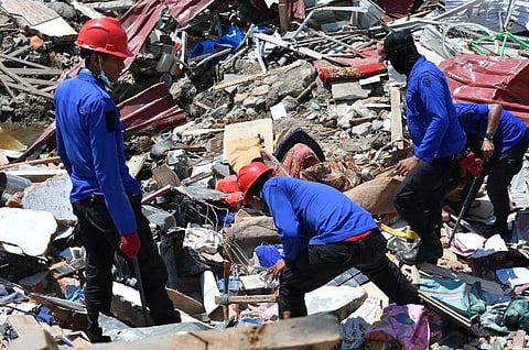 Rescuers search for survivors and dead bodies after the Indonesia Tsunami. (Photo | AFP)