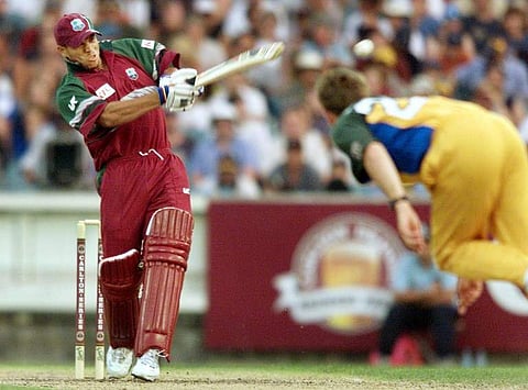 West Indies batsman Ricardo Powell (L) hits out against the Australian bowling of Ian Harvey (R) in their match at the MCG in Melbourne, 11 January 2001. (File | AFP)