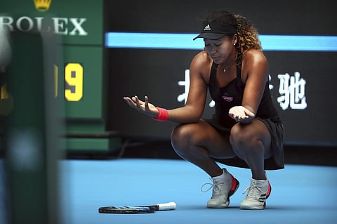 Naomi Osaka of Japan reacts while competing against Zhang Shuai of China in their quarterfinal women's singles match in the China Open at the National Tennis Center in Beijing. (AP)