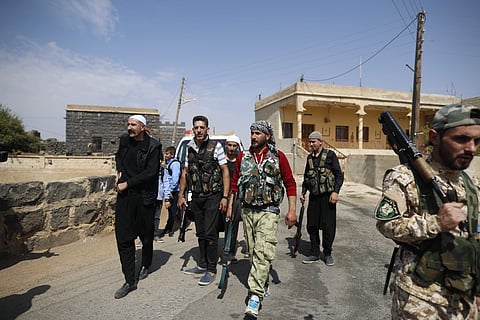 In this Thursday, Oct. 4, 2018, photo, young Druze armed men, who carry weapons to defend their village from Islamic State attack, patrol the village of Rami in the southern province of Sweida, Syria. (Photo | AP)