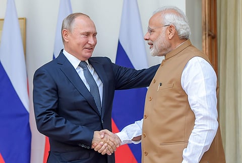 Prime Minister Narendra Modi shakes hands with Russian President Vladimir Putin before their meeting at Hyderabad House in New Delhi Friday October 5 2018. | PTI