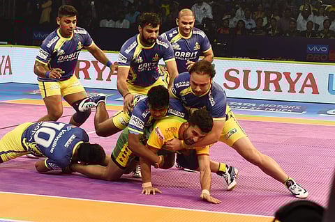 Players of Tamil Thalaivas Yellow Blue and Patna Pirates Yellow Green in action during their opening match of Pro Kabaddi league season6 in Chennai Sunday October 7 2018. | PTI
