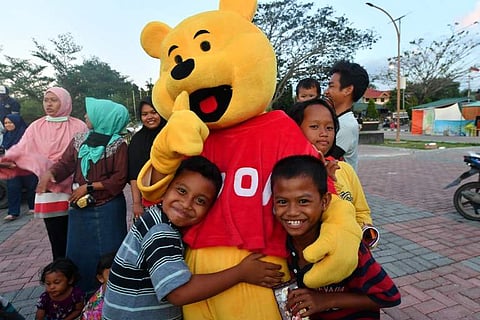 Volunteers are cheering up children across Palu with songs and games as the youngsters come to grips with a city hollowed out and twisted by nature. (Photo | AFP)