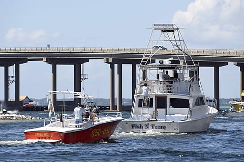 Commercial boats leave the Destin Harbor in Destin, Fla., on Monday, Oct. 8, 2018. Residents of this Florida panhandle city were busy Monday readying themselves for Hurricane Michael, which is predicted to make landfall somewhere around Panama City, Fla (