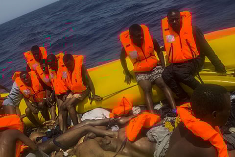 African migrants wait to be rescued by aid workers from the Spanish NGO Proactiva Open Arms next to the bodies of other migrants in the Mediterranean Sea (File | AP)