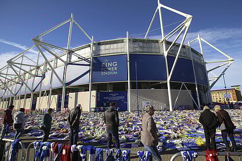 Visitors view the tributes outside Leicester City football club's King Power Stadium | AP