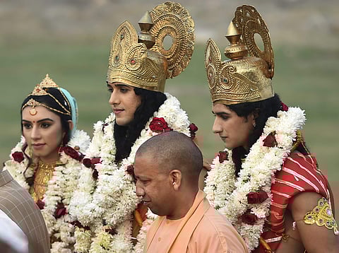 Uttar Pradesh Chief Minister Yogi Adityanath with the aristises dressed as Lord Ram Sita and Laxman after their arrival by choppers for Deepotsav grand Diwali celebrations in Ayodhya. (Photo | PTI)
