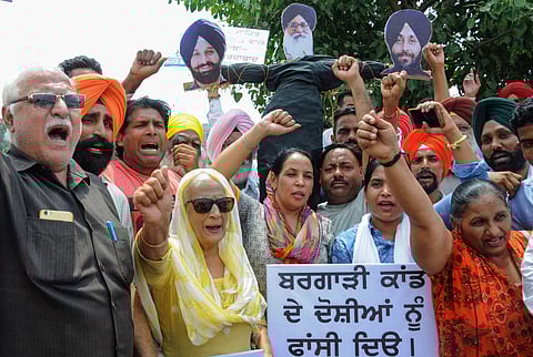 AAP activists protest against former Chief Minister Parkash Singh Badal SAD B president Sukhbir Singh Badal and Bikram Singh Majithia for their alleged role in the incidents of desecration of Sri Guru Granth Sahib in Amritsar on Thursday Aug 30 2018.