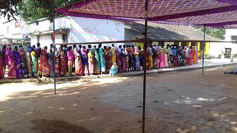 Tribals queue up in katekalyan Panchayat in Dantewada to exercise their electoral rights. (Photo| EPS)
